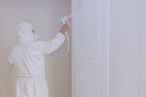 Master painting wood doors with spray gun processing painting