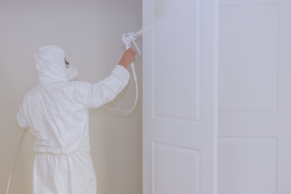 Master painting wood doors with spray gun processing painting